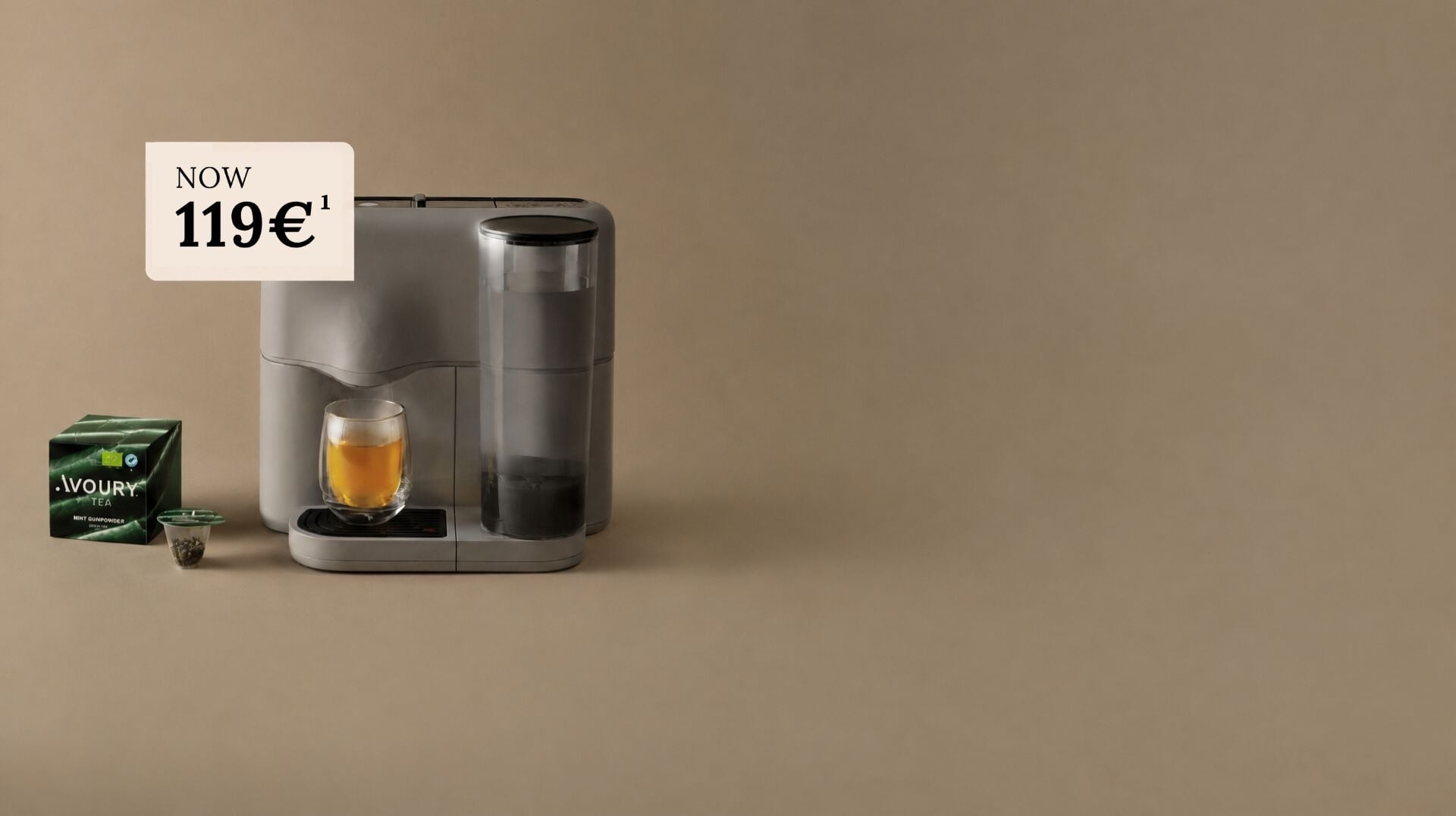 Avoury One tea machine in grey with a glass of organic tea