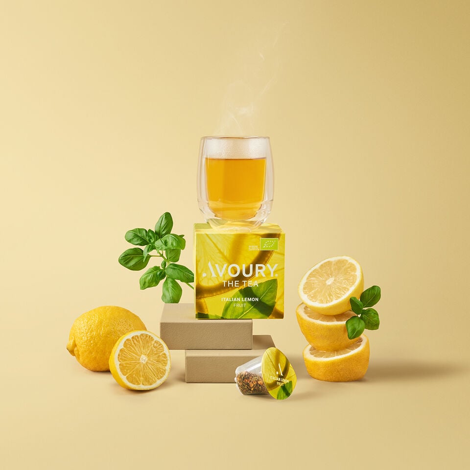 Avoury tea box ITALIAN LEMON coposed as a still life with a glass of tea on top and sideways each lemons